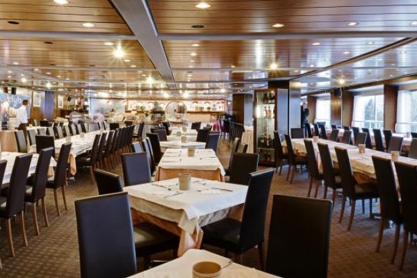 Restaurace s prostřenými stoly a židlemi.