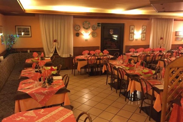 Restaurace s prostřenými stoly v teplých odstínech oranžové.