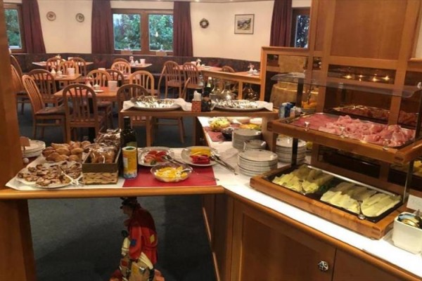 Bufetový stůl s pečivem, salámy a dalšími pokrmy v restauraci.